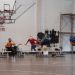 Dynamic wheelchair basketball game showcasing skill and determination indoors.